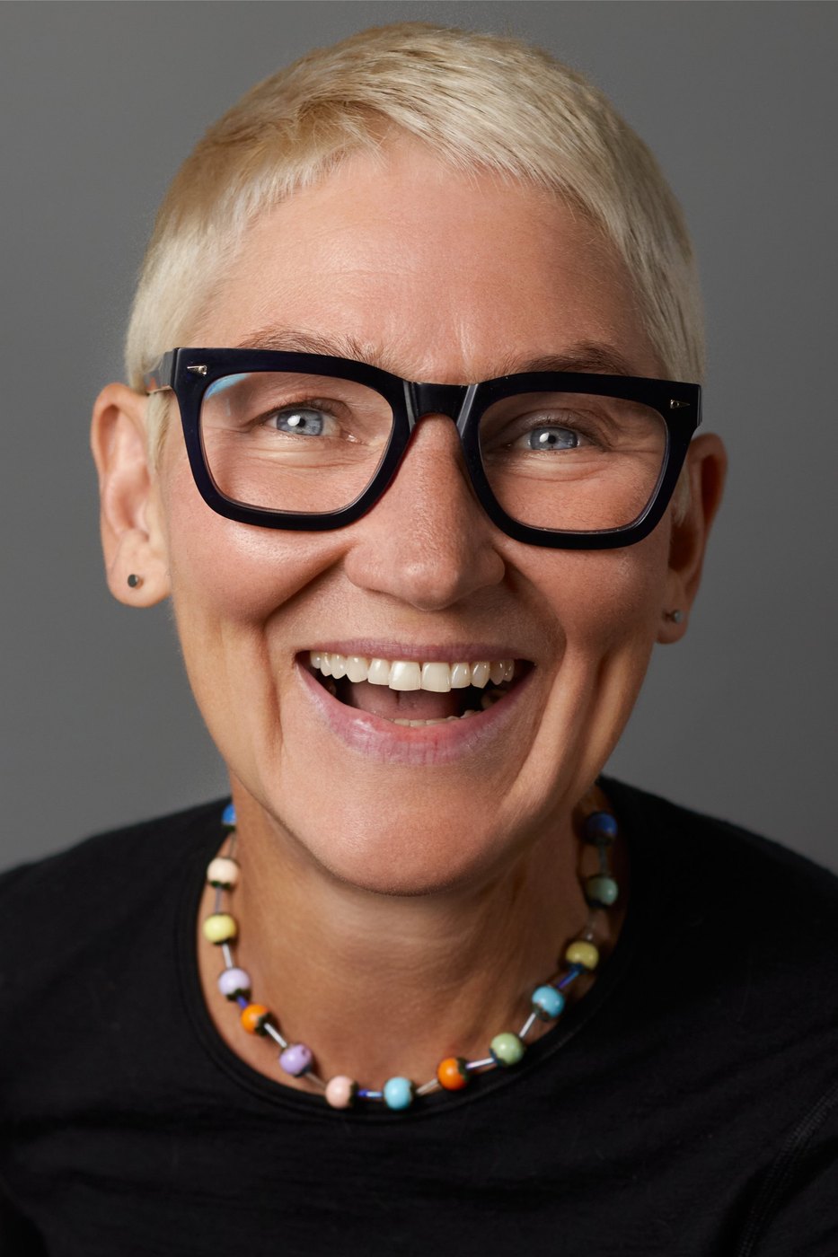 Monica, laughing portrait with black glasses