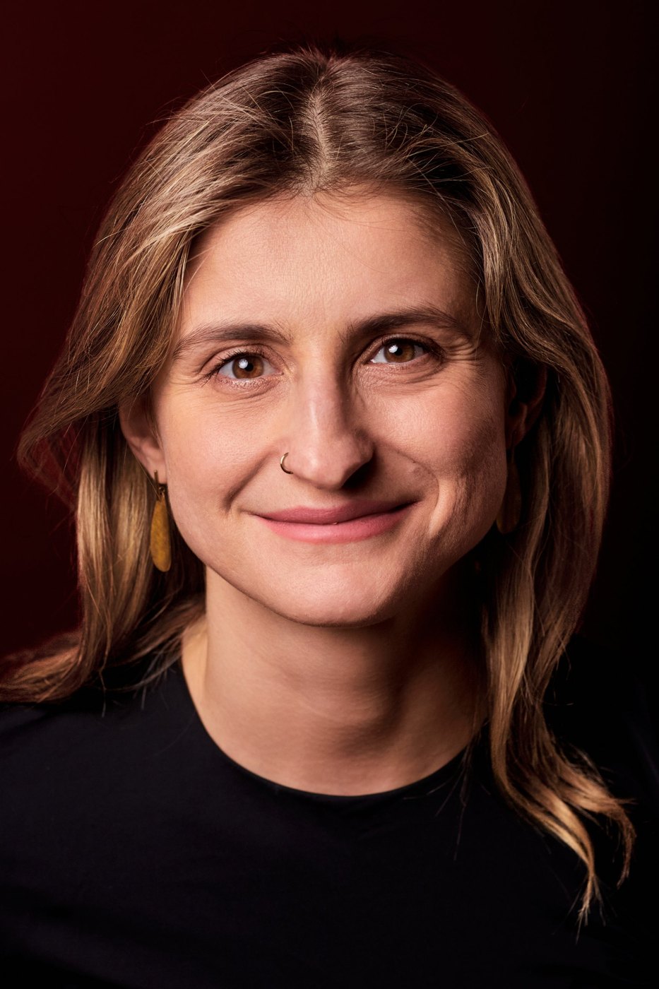 Hanna, portrait against a deep red backdrop